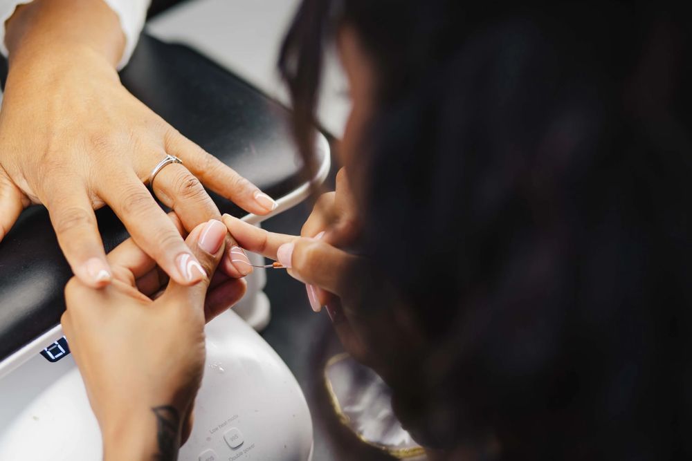 Thiara applying structured builder gel during a BIAB manicure in the Nottingham, MD private suite