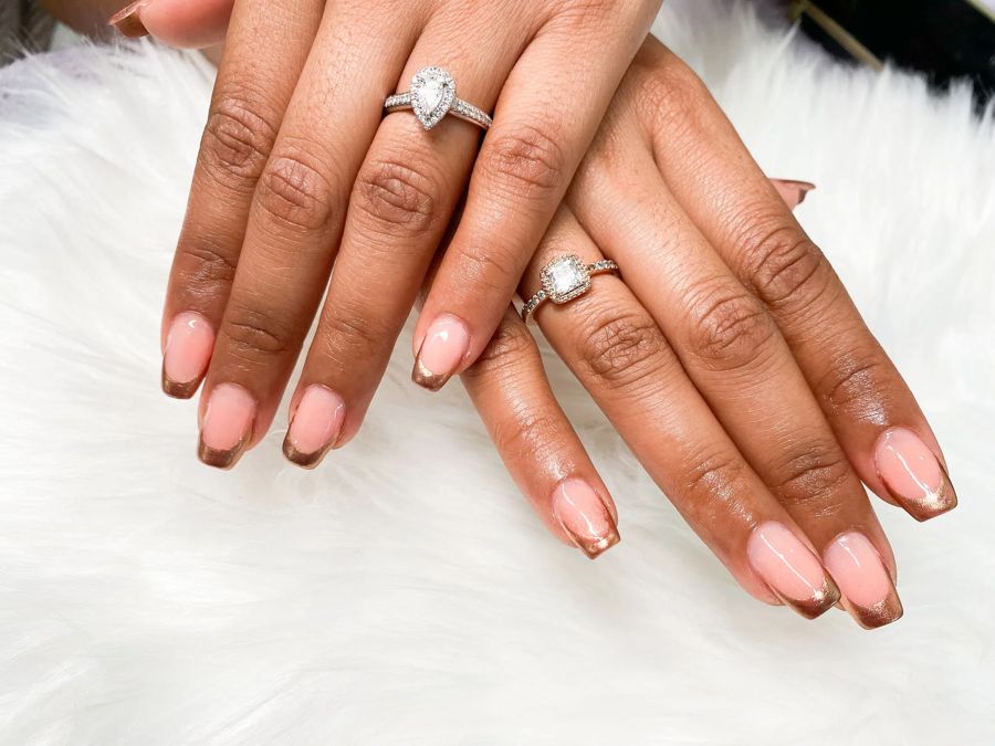Nude square gel nails with metallic bronze French tips by TLC Nails and Esthetics in Nottingham, MD