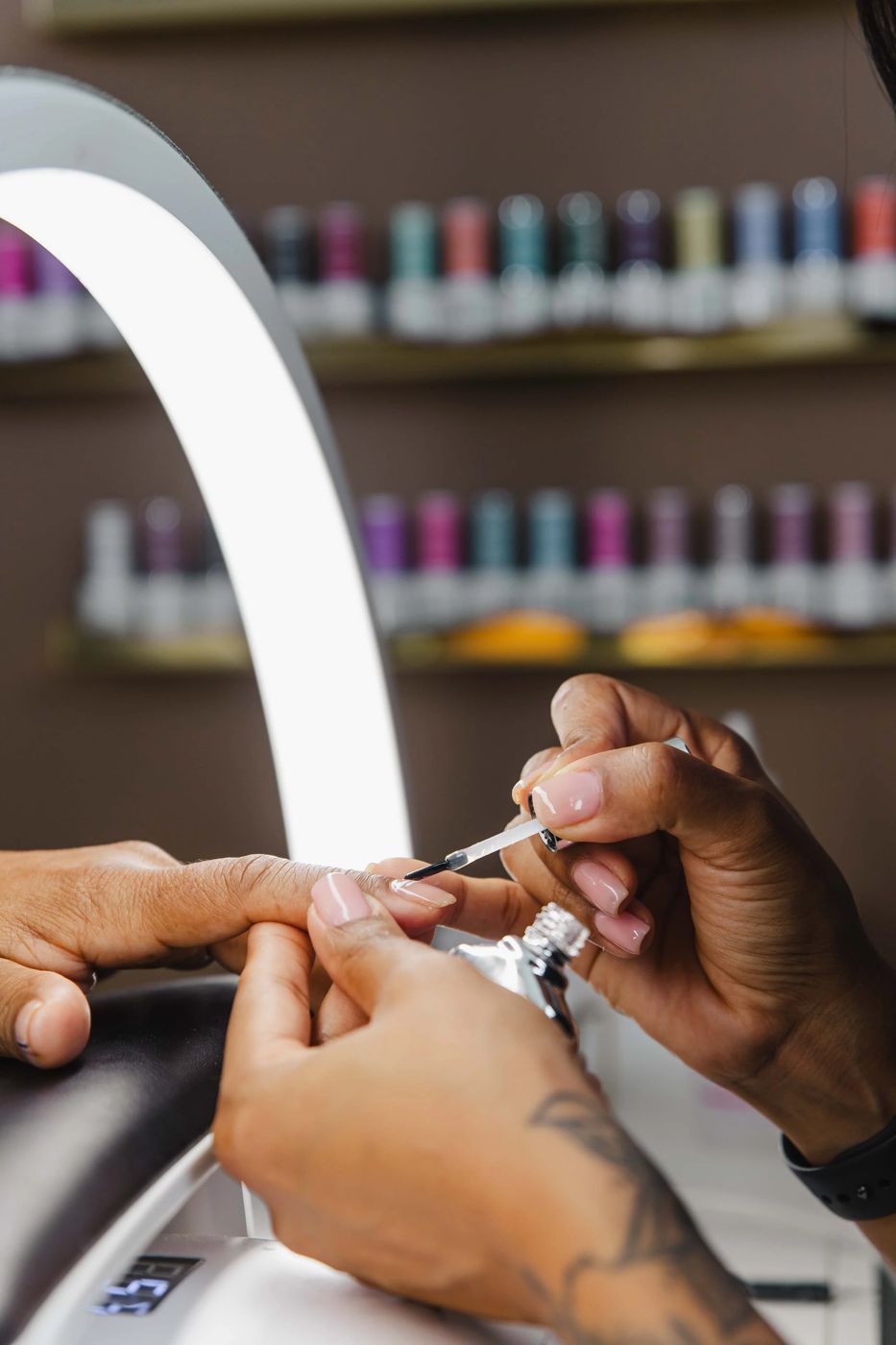 Thiara applying gel polish during a gel manicure at TLC Nails and Esthetics in Nottingham, MD
