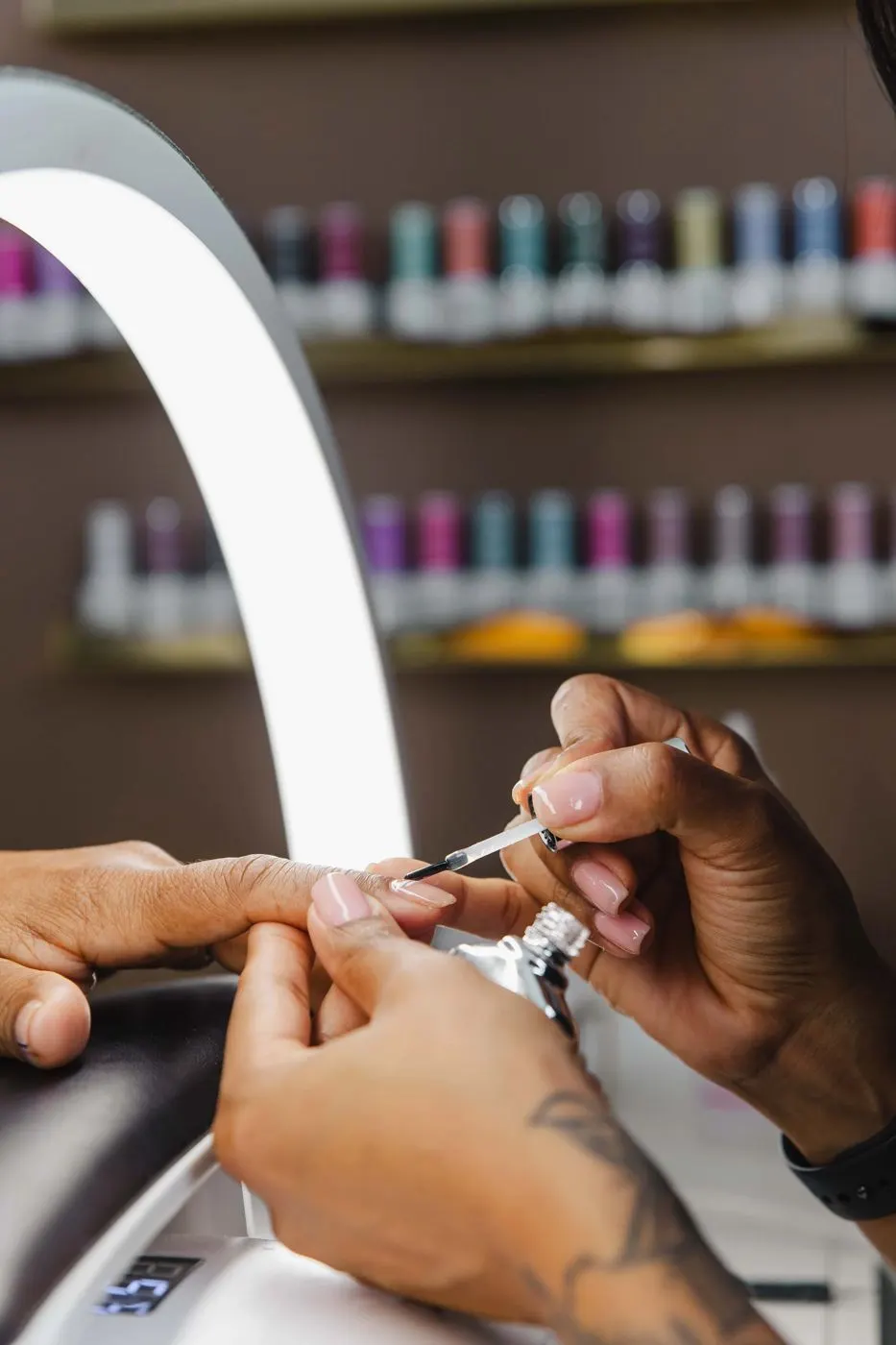 Thiara applying gel polish during a gel manicure at TLC Nails and Esthetics in Nottingham, MD