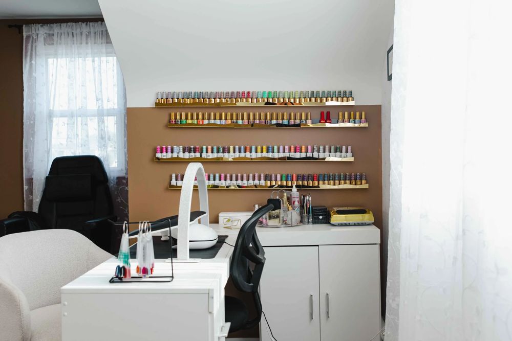 The private nail salon suite at TLC Nails and Esthetics on Belair Rd in Nottingham, MD, with the manicure table, client chair, and the full wall of gel polish colors