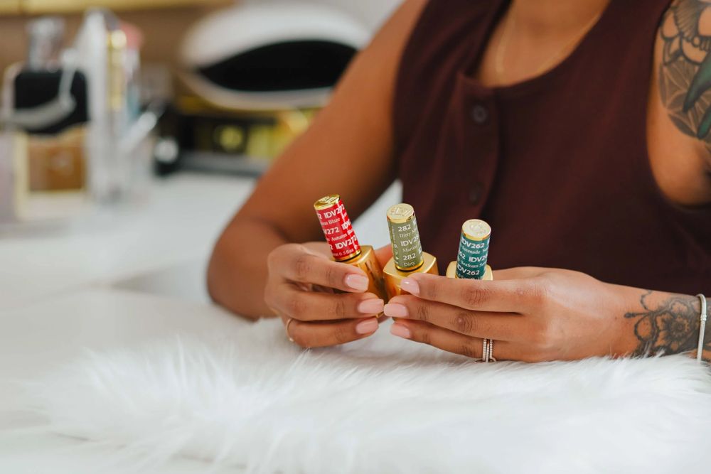 Gel polish bottles held at the desk while a client picks colors for her Gel X design at TLC Nails and Esthetics in Nottingham, MD