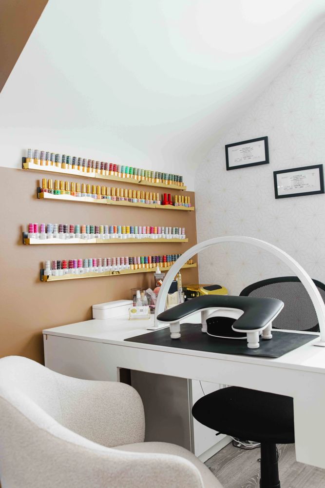 The private one-client suite where Gel X extensions are applied, with the LED lamp, racks of gel polish and Thiara's framed nail technician and esthetician licenses, TLC Nails and Esthetics in Nottingham, MD