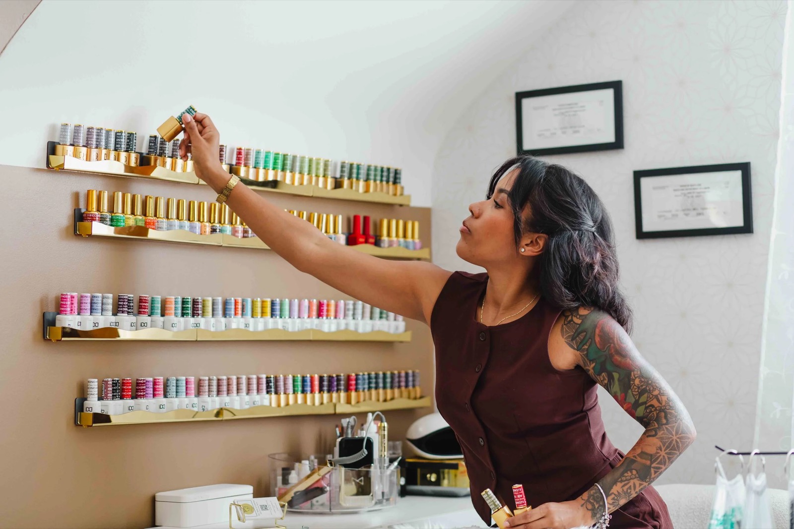 Thiara, licensed nail technician and esthetician, choosing a color in her private suite in Nottingham, MD